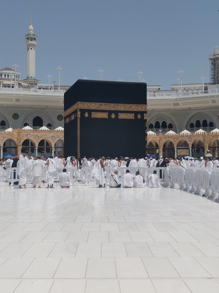 who-we-are Pilgrims in traditional attire perform rituals around the Kaaba in Mecca, Saudi Arabia.