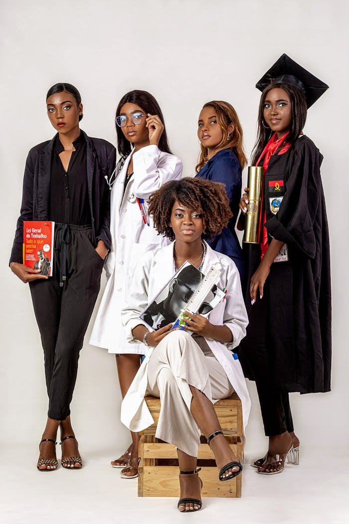 our-values A group of African American women posing in career-specific attire on a white background.